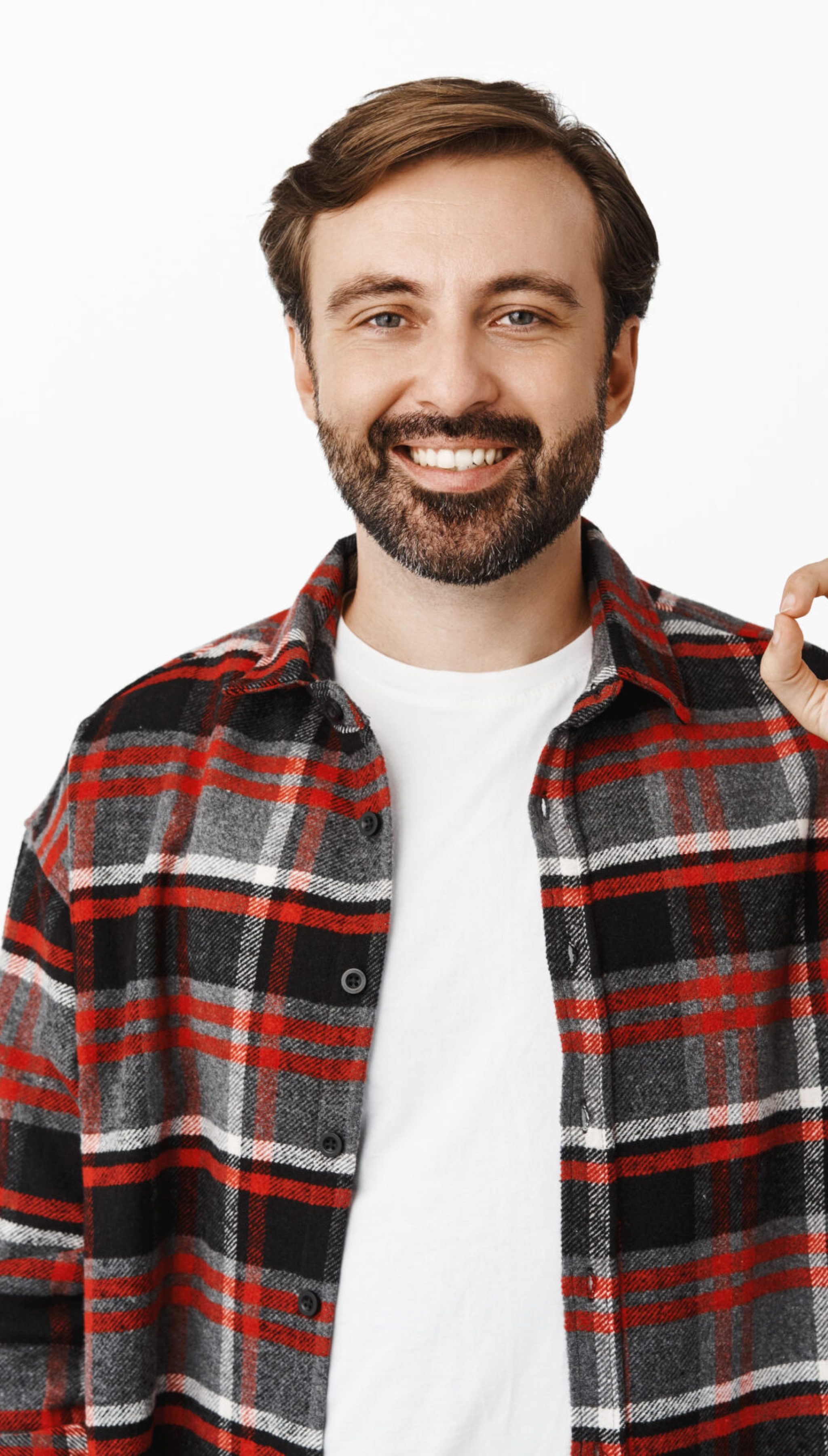 Handsome bearded guy shows okay sign and smiling, recommending something good, complimenting company, standing over white background.